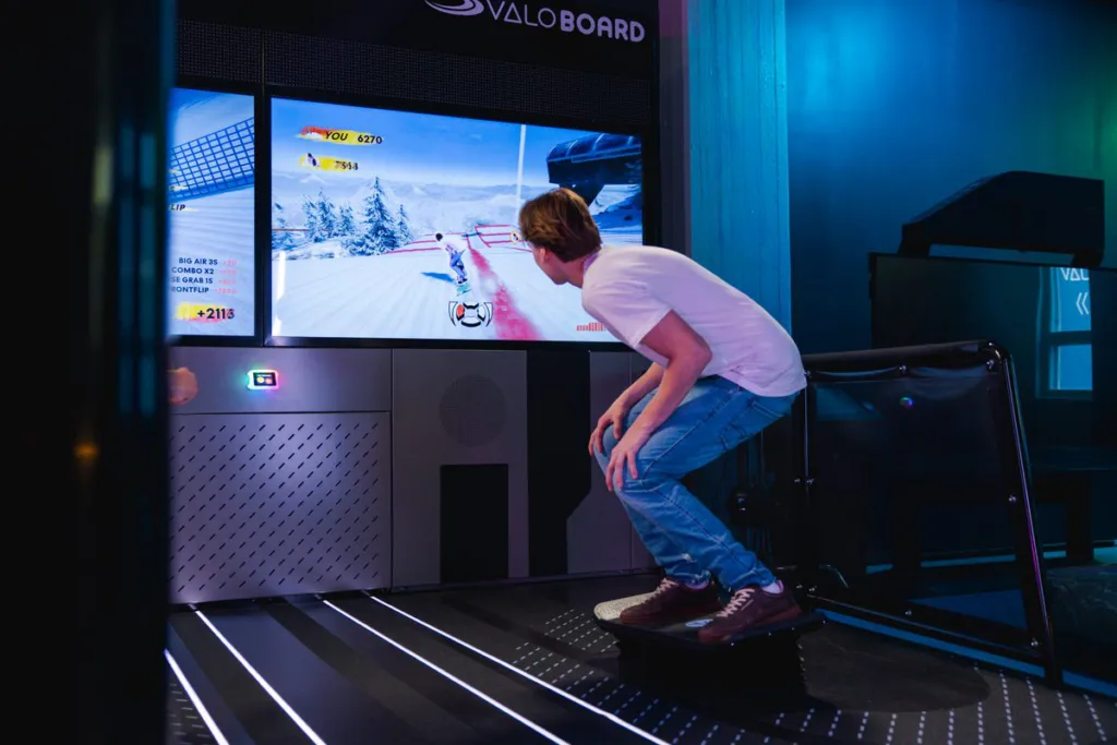 Spieler geht beim Snowboard-Spiel in die Knie